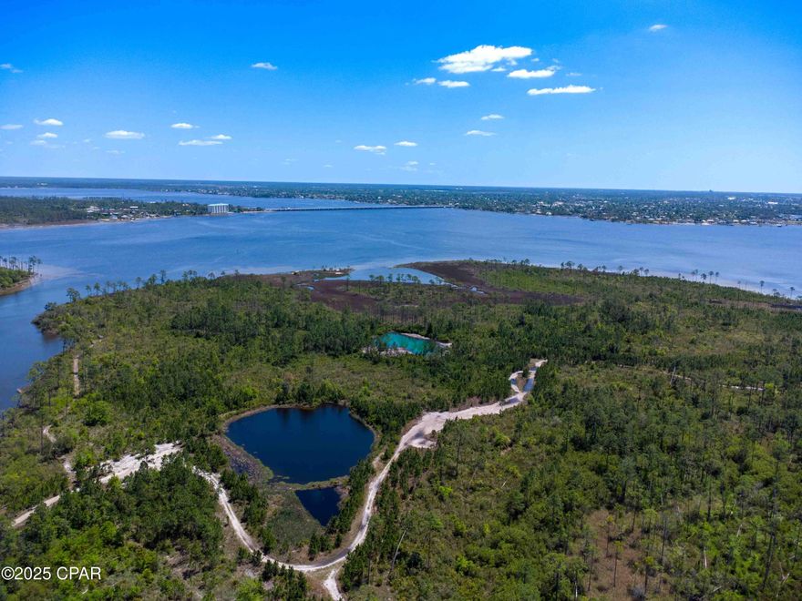 Rare ±231-acre waterfront development opportunity with ±8,000 feet of natural shoreline on North Bay — now available with flexible deal structures including seller financing and potential joint venture (JV) development partnerships. The seller is actively seeking qualified development partners and is open to creative structuring to bring this site to its highest and best use.

Strategically located in Bay County's rapidly expanding north side, the property is just minutes from Northwest Florida Beaches International Airport, Panama City Beach, and the multi-billion-dollar redevelopment of Tyndall Air Force Base. Adjacent to the established Fanning Bayou subdivision and close to Gulf Coast State College's North Bay Campus, this site sits squarely in the path of major regional growth.

Development Highlights:
* ±231 acres with ±8,000' of natural shoreline
* Previously approved for 218 residential units and a school
* Utilities nearby; excellent access to infrastructure and major roads
* Bay County planning supports new development in this corridor
* Ideal for residential, mixed-use, institutional, or recreational development

This is one of the largest contiguous, undeveloped waterfront parcels remaining in the area. With strong regional demand, supportive zoning, and a seller willing to structure a deal creatively—including JV partnerships—this property offers a compelling opportunity for developers and investors looking to capitalize on Northwest Florida's growth.
