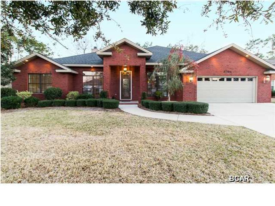 This remarkable 4 bedroom (plus an office), 3 bathroom, all brick home is a one of a kind. Located in Phase 5 of the hammocks (larger, custom style homes), this home will impress you the second you walk in. The grand entry features beautiful hardwood floors and custom trim work. This same high end flooring runs throughout the formal dining, kitchen, living room, and breakfast area. The attention to detail in this home is unlike any other you'll see. The crown moulding, very elegant tray ceilings, real brick wall in the kitchen, high-end appliances, and a kitchen straight out of a luxury homes magazine will have you ready to move in. The master bathroom features double sinks, Jacuzzi tub, separate shower, and a huge walk-in closet. On top of all this, the backyard is amazing. Your