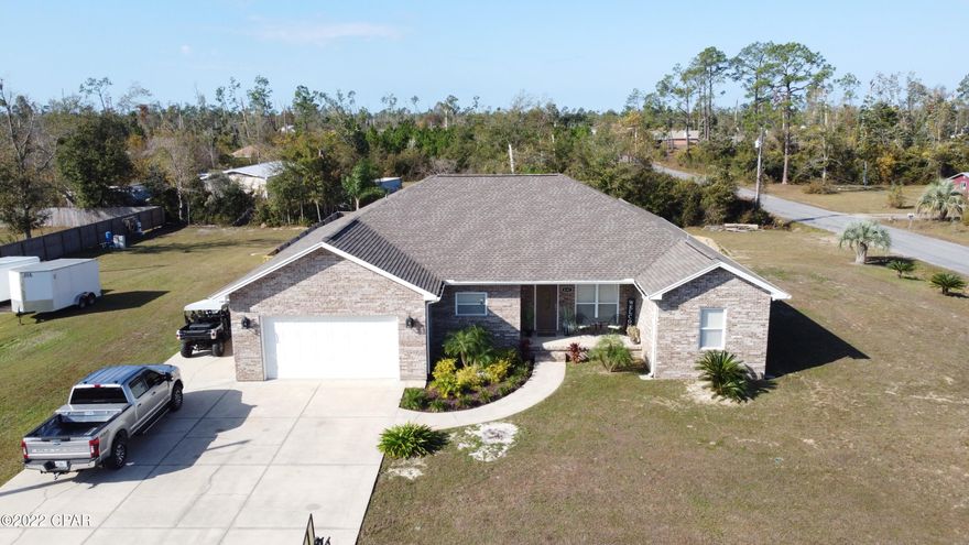 Amazing All Brick custom build on nearly an acre! Your outdoor oasis awaits! Pool and custom pole barn for entertaining, beautiful landscaping. A must see! Enter into an open concept floor plan offering a cathedral ceiling in living space and 9ft ceilings everywhere else. Recessed lighting in main rooms and porcelain tile throughout This home is bright and airy with plenty of natural light. Spacious kitchen features custom cabinets and plenty of counterspace. Stainless steel appliances. Very nice half bath off the main space with shiplap and granite countertops. French doors off the living room leads to a covered back patio overlooking the pool.  Master suite features French doors to the pool/patio, huge walk-in closet, double vanities with granite, and stand-up shower. 2 additional guest rooms that are nice sized and guest bath is spacious with granite countertops and plenty of storage. Huge Bonus room that was used as two bedrooms, would also be perfect for a game room or media room. Has hot/cold tap and drain installed when constructed to add a wet bar. It also has french doors that lead to covered back patio. The outdoor space of this home is absolutely perfect for entertaining family and friends, from pool parties to outdoor dining it has the space to hold large groups. Beautiful greenery including satsuma, blueberry, and banana trees. Two car garage and plenty of parking for RVs, boats, or guests. Garage was plumbed for a sink when constructed. New roof after the storm with full ice/water shield. Stood tall to Michael with only minimal shingle loss. Transfer switch for generator. Outdoor shower. Paradigm surround speakers in wall and ceiling in living room. The bonus room/4th is also wired for ceiling speakers. Laundry room has direct entrance from garage or home and has built in cabinets. This home has been cared for and maintained with an open wallet and pride of ownership shows throughout. On well and septic so no water bill. No HOA. Great proximity, just 15 minutes to 23rd St shopping/restaurants and Panama City Mall. Only 25 minutes to Tyndall Air Force Base and 30 minutes to Panama City Beach. Nice and quiet without neighbors 6 feet away.