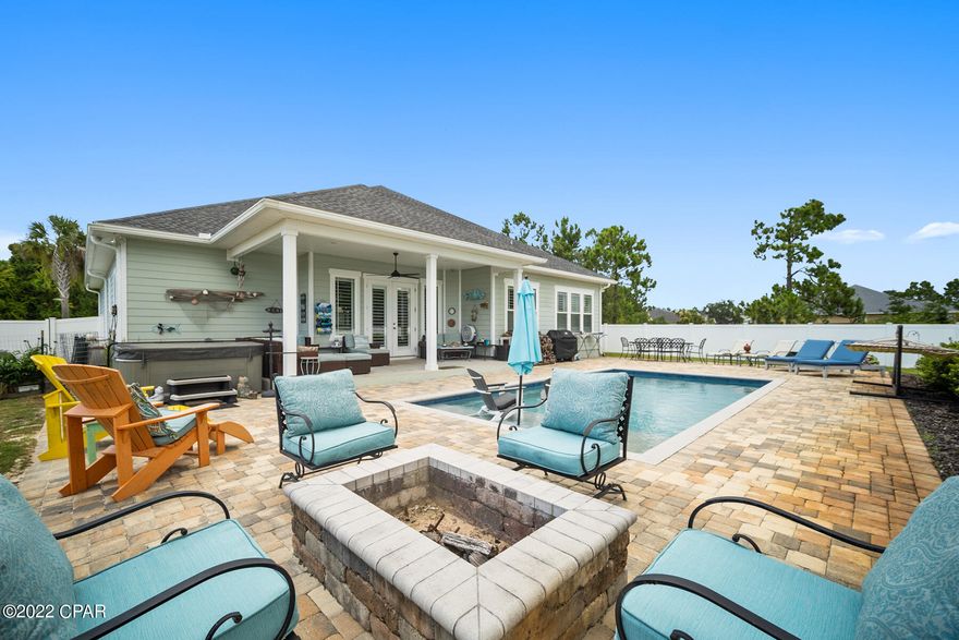 CURRENTLY UNDER CONTRACT - SELLER WILL CONSIDER BACKUP OFFERS. This gorgeous, bay view, coastal craftsman pool home is a must see! This four bedroom, three bath home with formal dining room is conveniently located in the prestigious gated waterfront/marina community of Dolphin Bay. As soon as you enter you will fall in love with the inviting open concept plan with split bedroom design to include two master bedrooms. The stylish kitchen features granite counter tops, stainless steel appliances and creates an inviting atmosphere that opens nicely to the living area overlooking the large inground pool with sweeping views of the bay. Some interior upgrades include crown molding throughout, beautiful porcelain wood tile flooring, 12 foot tray ceilings, recessed lighting, plantation shutters throughout, and an alarm system. The exterior upgrades include a rain gutter system, sturdy 2x6 construction, hardie board siding with beautiful stonework, fenced in backyard buried 3 feet deep for extra durability, fire pit, new saltwater inground pool with sun shelf, gorgeous paver decking, beautiful landscaping, automated irrigation system, large covered patio, and located on a private corner lot with gated access for boats/kayaks. In Dolphin Bay homeowners are allowed to keep boats and campers behind their privacy fences. With the convenient location to the neighborhood marina just down from this home, you will relish in the ease of getting to the gulf within minutes of leaving your home. This community also has tennis, pickleball, and a basketball court for homeowners. Dolphin Bay is conveniently located at the foot of the Hathaway bridge making it a breeze to reach the beaches, Panama City, or nearby shops and restaurants in Panama City Beach. The hot tub can be negotiated if desired. Please schedule your appointment to see this one-of-a-kind oasis today! Please note that all measurements and information are deemed accurate but must be verified if important.