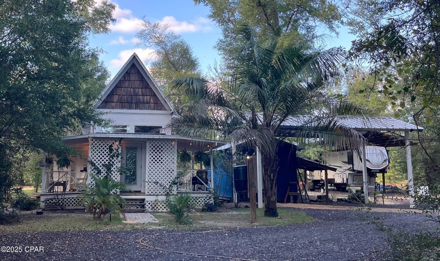 Charming Cabin Retreat on 2 Acres with Modern Comforts & Country Charm!

Discover peaceful country living in this beautifully crafted 1-bedroom, 1-bathroom white cabin nestled on 2 serene acres in Altha, FL. This cozy 468 sq ft home is full of character, featuring hickory hardwood floors, tongue-and-groove walls, and custom hickory cabinets that bring a warm, rustic elegance to the space. The cypress landing and gas stove with a buried propane tank add to the home's thoughtful details and efficiency.

Enjoy the privacy of your own space—one full acre is completely fenced with an electric gate, perfect for pets, gardening, or simply relaxing in your peaceful surroundings. Outside, you'll find two storage sheds (one powered and insulated), a 24x36 pole barn with a 50-amp RV hookup, a chicken coop, and a koi pond with irrigation, creating a true homestead retreat.

A brand-new well was just installed in October 2025, providing reliable fresh water for years to come. A recent survey is also available, saving you both time and money. Conveniently located off a main paved road, you'll love the easy access to Highway 231, giving you a straight route to Panama City, FL or Dothan, AL—so you can enjoy both small-town serenity and nearby city conveniences.

Whether you're looking for a primary home, weekend retreat, or investment property, this cabin checks every box. Come experience the peaceful charm of Altha and see why this hidden gem won't last long!