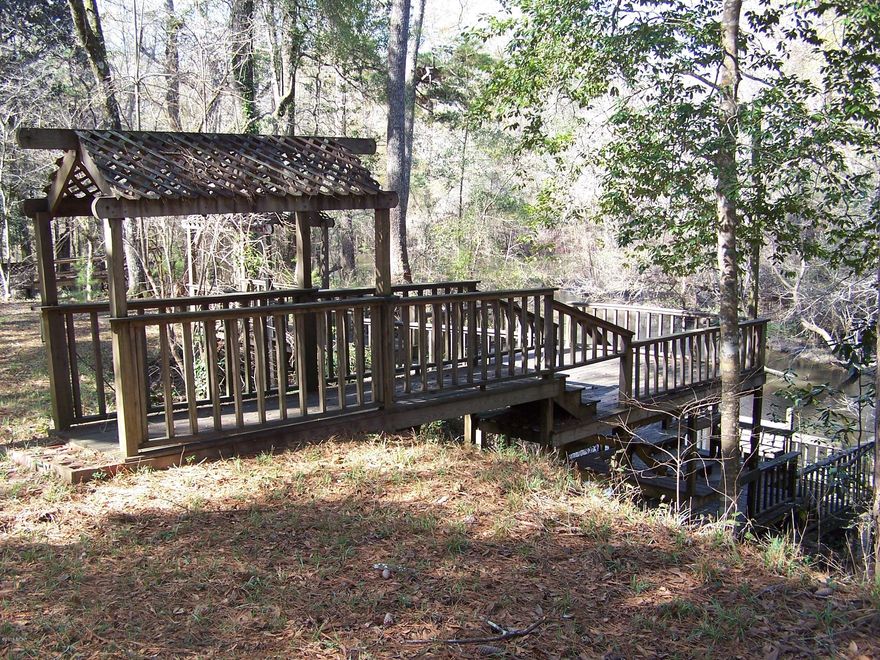 Approximately 140 feet of Creek Frontage! View the nice winding Creek from your own multi tiered Deck & Dock or the 50x12 Rear Deck attached to the home. Perfect for any type of Buyer; Retirement, Second Home or First Time Home Buyer. This Golf Course Community surrounds an 18 Hole Course with Club House and Snack Bar. When you tire from Fishing off your Dock, ride your Golf Cart over tot he course for a quick round!
