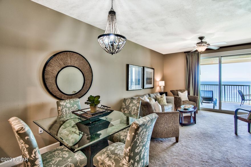 Fantastic 2BR Gulf front condo with hallway bunks & Gulf front master bedroom! Floor to ceiling windows & doors offer incredible views of the Gulf & pristine beach below. The large balcony is great for relaxing while listening to the waves & enjoying breathtaking views of the sugar-white beach & emerald green waters of the Gulf. Enjoy outdoor Gulf front dining with the table on the balcony. This unit comes fully furnished & decorated making it a great turnkey investment. The beautiful kitchen features recessed lighting, granite countertops, tile backsplash, ample cabinets, pendant lighting over the breakfast bar, and stainless steel appliances. The open floor plan makes dining, entertaining, and relaxing easy! The dining area currently seats 4 with room for 3 at the breakfast bar. The master bedroom is Gulf front with direct access to the private balcony and offers an en-suite bathroom with tile floor, double vanity, large soaking tub, and walk-in shower. The master is nicely appointed with a king bed and flat screen TV. There is a spacious guest bedroom with serene views of Grand Lagoon and direct access to the guest bathroom. The guest bathroom is also conveniently accessible from the hallway where the bunks are located. There is a stackable washer & dryer for convenience. 

Grand Lagoon amenities include a Gulf front pool, hot tub, beachfront patio, tiki bar, fitness center, and a second pool also offering with peaceful views. Take advantage of this incredible opportunity to own an amazing condo with great amenities. The Emerald Coast is home to some of the world's most beautiful beaches and Unit #1803 truly captures that!