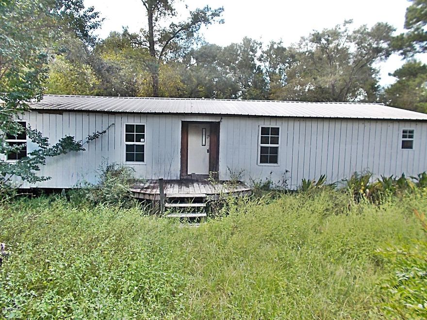 Hunters Paradise..... Prime wooded acreage on a county maintained graded road about an hour from Tallahassee, includes well,septic & three phase electric, surrounded by natural forest and a spring creek on the back of property, the home needs some work but would be ideal for a hunter camp or weekend home.It is also about 4 miles to the boat landing for Ocheesee Pond a 2000 ac lake. The home has a metal roof on it. The owner will subdivide or would do some owner financing. Call agent for details.