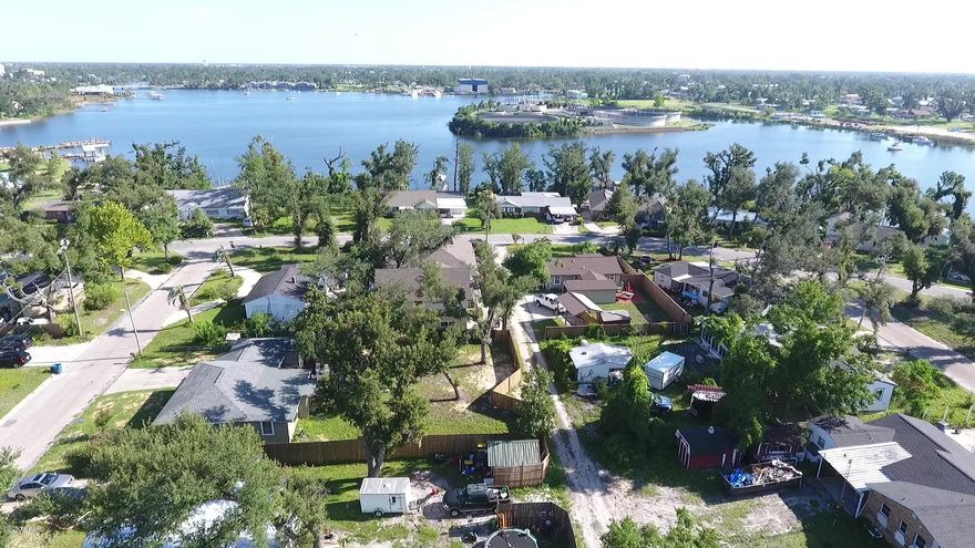 Main House: 3BR, 2 BA 2162SF, Open floor plan, large cooks' kitchen with custom cherry and maple cabinets.  Bosche appliances, 2 pantries, dining room, gas fireplace, 2 offices, laundry room, reclaimed pine floors with tile bathrooms.  Carriage House: 1 BR, 1 BA, 773 SF. Full kitchen, reclaimed pine floors alley access.  Shop:  1/2 BA, closet, 773 SF, heated/cooled.  Can be converted to game room, garage, apartment, etc.  Sliding Door opens to alley.  Professionally landscaped yard with circular drive, 36' paved parking for boat or RV - no grass.  ''Charleston style'' flagstone enclosed courtyard with lighted fountain, 2 large oaks. fire pit, covered bar/grilling shelter. Attached 2-car garage.  Elevation 30'.  Major hospital 1.4 miles.  Boat launch 1.6 miles  Full details in MORE DETAILS, 1702 Tyndall Drive, Panama City, FL 32401

Enter the circular concrete driveway with plenty of parking and note the professional landscaping. Step onto the covered front porch and enter the foyer which invites you into an open floor plan. Notice the high-quality construction and detail everywhere-old growth longleaf pine floors, solid wood doors with upscale hardware, smooth drywall ceilings and all LED lighting. The living area has lots of windows, built-in bookcases and a gas fireplace. The dining room has built-in shelving and drawers, and a large arched window. Just through the barn door off the dining area is a small study with built-in birdseye maple countertop and another large window. The large cook's kitchen is all custom with cabinets of maple and cherry with dovetail, soft-close doors and drawers. Granite covers the countertops, including the coffee bar and dry bar. There is a separate walk-in food pantry and an appliance pantry nearby. All kitchen appliances are Bosch and the downdraft cooktop is gas. There is a conventional oven with a separate microwave/convection oven.

The generous master suite has the same high-quality construction and finishes. Through French doors is a craft room/workroom with new professional grade carpet and large windows for plenty of light. The master bath is tiled. has a custom mahogany vanity with quartz countertop and a linen closet. Walk through the large glass shower to a large private outdoor shower. Nighttime stargazing from this shower is fantastic! The spacious walk-in closet with a custom chest of drawers on each side has plenty of hanging space and a large shoe rack. Conveniently located off the hallway to the master bedroom is the laundry room with utility sink, fold-up ironing board and linen closet. The other two bedrooms share a recently remodeled full bath with custom cherry vanity, quartz countertop and hand painted

sink, along with a deep soaking tub and handheld shower. The covered walkway off the kitchen takes you to a two-car garage with pulldown ladder to access attic storage space. Off the walkway, step through the screened door to a private, Charleston-like back yard where two large oaks anchor the landscape. There is a lighted stone fountain, flagstone paving, a 9'x13' covered grill area with tiled bar and storage, and party lights. A vine-covered fence completes this oasis.

Across the courtyard, you will enter a 22'x36' heated and cooled woodworking shop with its own electrical panel, half bath, storage closet and fire sprinkler system. With access to the alley through large sliding doors, this space has endless possibilities. A separate stair leads to the carriage house apartment above. From the coved ceiling with indirect lighting to the old growth pine floors, custom cabinets and doors, and built-in hand carved birds, you will again notice the detailed quality construction and experience the comfort of this living space. Everything is here - kitchen with stainless steel countertops and pantry with barn door, built-in desk and shelving in the living area, bedroom with built-in headboard and double-door closet, and full bath with large tiled shower and laundry area.

All in all, you won't find a more livable, comfortable, well-built home. Exterior maintenance is minimal with brick and cement board siding.

Additional Information

"Concrete pad to park an RV up to 36' in length of circle driveway
mailbox enclosed in brick

"No grass to mow

"Elevation of the house is 30 feet above sea level

"Old growth pine flooring in the main house was salvaged from the bottom of the Sewanee River. Old growth pine flooring in the carriage house was salvaged from the bottom of the Choctawhatchee River.

"Coat closet in entry foyer

"Automatic off/on lighting in the food pantry

"Built-in night lighting in the carriage house

"Motion sensor lighting in the workshop.

Items that do not convey:

"Front porch swing

"Wind sculpture in the back yard 

"Custom stain glass in the office off the dining room