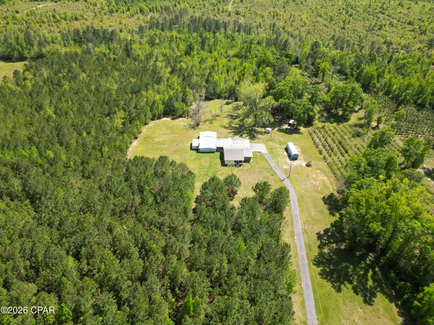 Welcome to 2527 Frost Lane in Chipley, a spacious 2-bedroom, 2-bathroom home offering 2,634 square feet of living space on 20.50 beautiful acres just off Pioneer Road, providing quick and convenient access to Highway 77. The home features a durable brick and vinyl exterior with a metal roof, along with a flexible floor plan that offers the potential to be reconfigured into a 3-bedroom, 2-bathroom layout. One of the bedrooms includes an attached space that could easily serve as an office, sitting room, nursery, or additional bedroom, depending on your needs. The property offers an abundance of covered parking, including an attached garage with space for at least three vehicles, as well as an attached carport with room for multiple additional vehicles, equipment, or recreational toys. Outdoors, you'll find eight pecan trees and plenty of room to enjoy the peaceful setting. The land includes two wells, one of which is not currently working, and three septic systems, offering the possibility for a second homesite with county approval. With a 5-year-old HVAC system, generous acreage, versatile living space, and exceptional parking and property features, this unique Chipley property is full of potential.