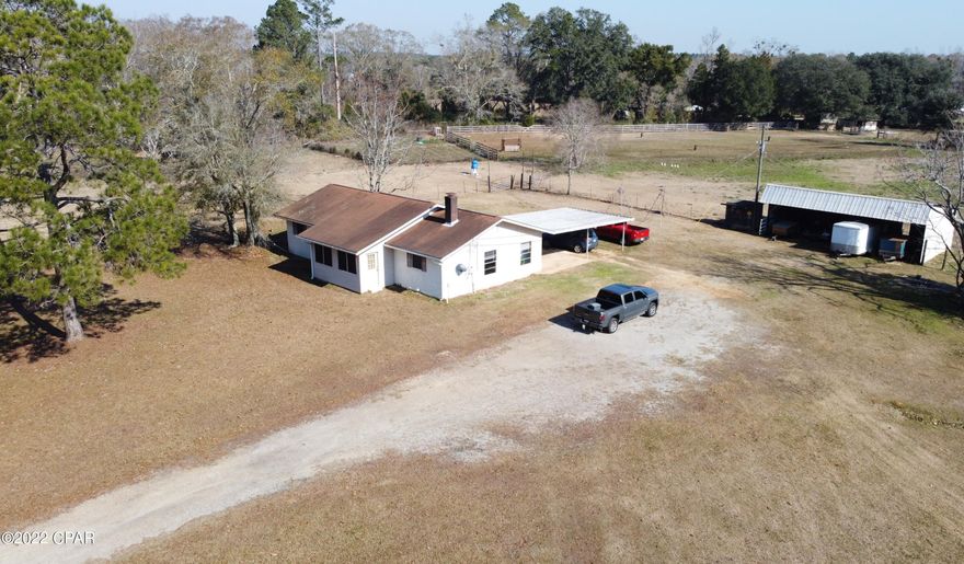 CURRENTLY UNDER CONTRACT, SELLER ACCEPTING BACKUP OFFERS. This 3/2 home sits on 3.1 +/- acres with an open concept floor plan. This home is just far enough out to have the country feel and space but yet a short drive to town. The main living area offers plenty of space, lvp flooring, and ship lap fireplace. Attached is a 2-car carport to the backside of the home. The 40x24 barn offers nice space for parking extras or for housing your animals. The acreage offers plenty of space for the kids to play or pets to roam.