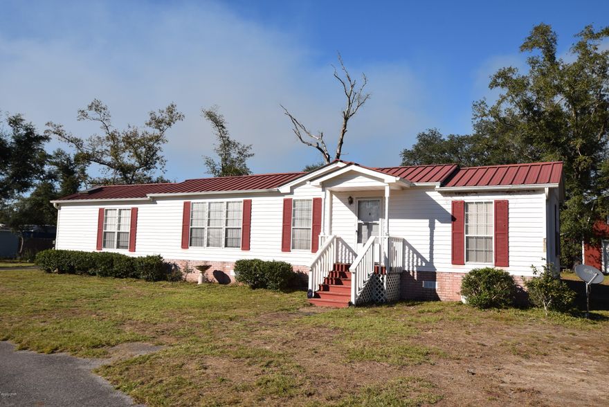 Well maintained mobile home on 0.86 acres! The 2Br/2Ba singlewide comes fully furnished. There is a large family room addition on the home for more space.  The kitchen has an island and plenty of cabinet space. Wood and tile flooring in the main living areas. The workshop with the carport is fully wired and there is a huge 2 story barn. The drive way is asphalt.  Econfina Estates is located just minutes from Econfina Creek Recreation area and only 20 minutes to town. All measurements are approximate, verify if important.