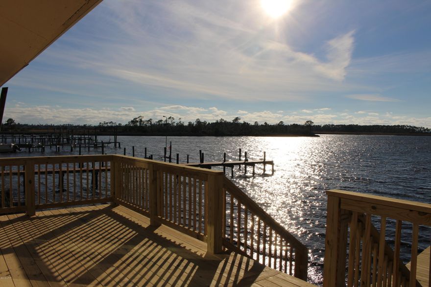 Huge BAYFRONT townhome! Centrally located in Panama City.  Enjoy endless views of the bay and perfect sunsets every day from your back deck and you will also have the longest dock in the neighborhood to park your boat! BOAT LIFT for up to 22ft boat. This property has been well maintained and updated, over sized garage and low maintenance yard are just some of the features you will enjoy!