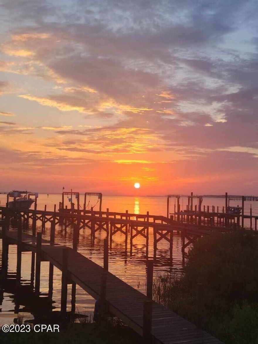 Under Contract will consider back up offers. Do you love gorgeous sunsets?  This is the place to be!  This beautiful, bayfront townhome has many updates including a new dock and updated bathrooms.  The back deck is sure to delight with the perfect view of sunsets over the bay. This is a perfect home for entertaining as the open concept living room, dining room and kitchen open onto the beautiful deck.  There are no HOA fees! You MUST see this home. None of these bayfront townhomes have been for sale in more than 2 years.  All measurements are approximate and should be measured if important.