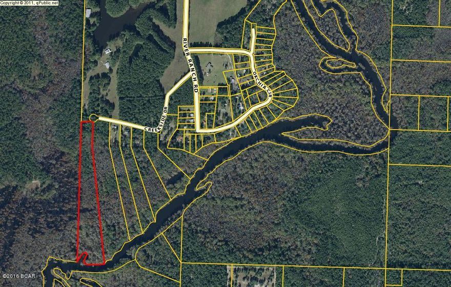 Seldom available acreage in River Ranch Retreat subdivision now available. River Ranch is a small older subdivision with a private boat launch into Holmes Creek, plenty of parking, and an event pavilion for gatherings. This parcel contains 9.5 Acres in total and is an a very private location. Bring your boat!