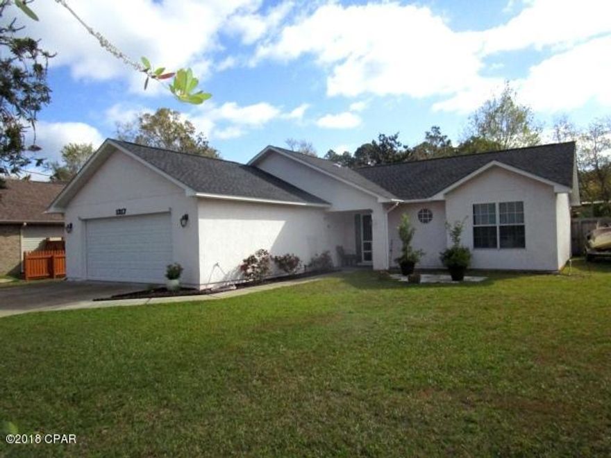 IMMACULATE LYNN HAVEN HOME located on a one-third acre lot with a screened, in-ground pool!  This home features a kitchen that is open to both the Great room and large dining room with laminate wood flooring throughout!  The split-bedroom plan features a good-size Master bedroom and a Master bath with a double vanity, ceramic tile flooring and a shower/tub combination.  The two additional bedrooms are a good size and conveniently located near the second full bath.  Outside you will find a covered porch that opens to the spacious screened pool area, yet the fenced yard still has plenty of room for outside play areas!  This home is in move-in condition with a new roof, a/c unit that is just a year old, hurricane shutters for the windows and so much more.