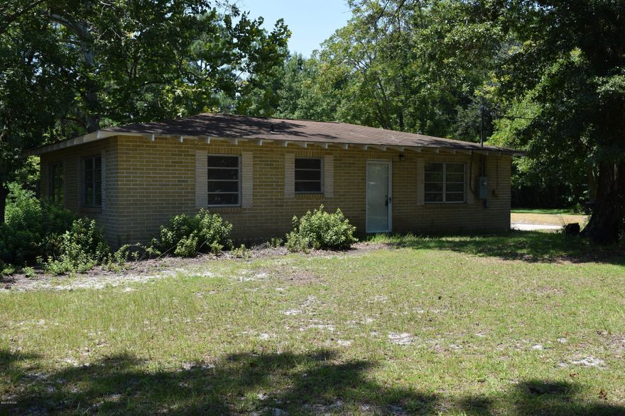 Beautiful 2 acre parcel in town.  Plenty of old growth trees- Long Leaf, Maple, Pecan, Catawba, and oaks.  Lush grass, flowering bushes and plants abound!  There even was a pond on the property at one time that has been filled.  Don't worry though, none of this property is in a flood zone. The house was built in the 50's and is rock solid.  The exterior bricks are actually 8 inches deep like a concrete block.  The home needs some TLC, but can be moved into immediately.  Split the 300ft wide lot and have 2 home sites, build a house and have a rental, or renovate the existing home and have your own country property in town!