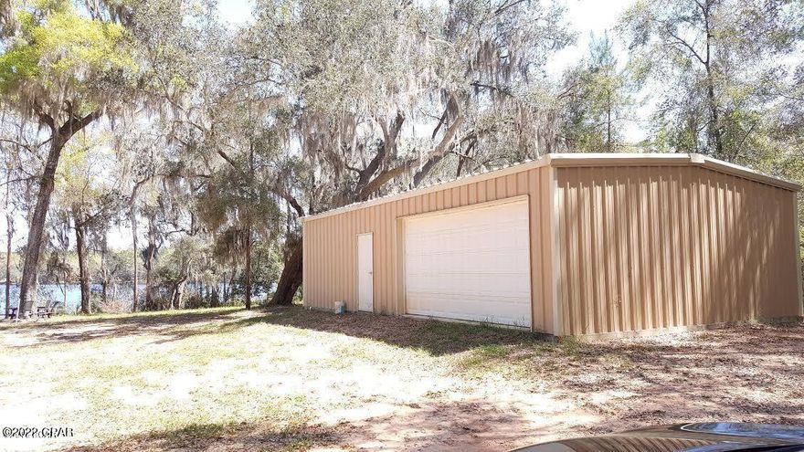 Beautiful Dunford Lake lot in the Dunford Haven section of Paradise Lakes. This 1.7+/- lot is mostly cleared and slopes gently to the 45' dock to fish for Bass, Bluegill and Crappie in this spring fed lake. There is a 25'x40' metal building with concrete floor, insulation, and a bath with a shower. Property has a well and septic in place. This is a great place to sit back and enjoy nature at its finest. Up to 25 hp engines and a maximum speed of 15 mph on lake. There is a community boat ramp. Approx. 45 minutes to Panama City Beach.