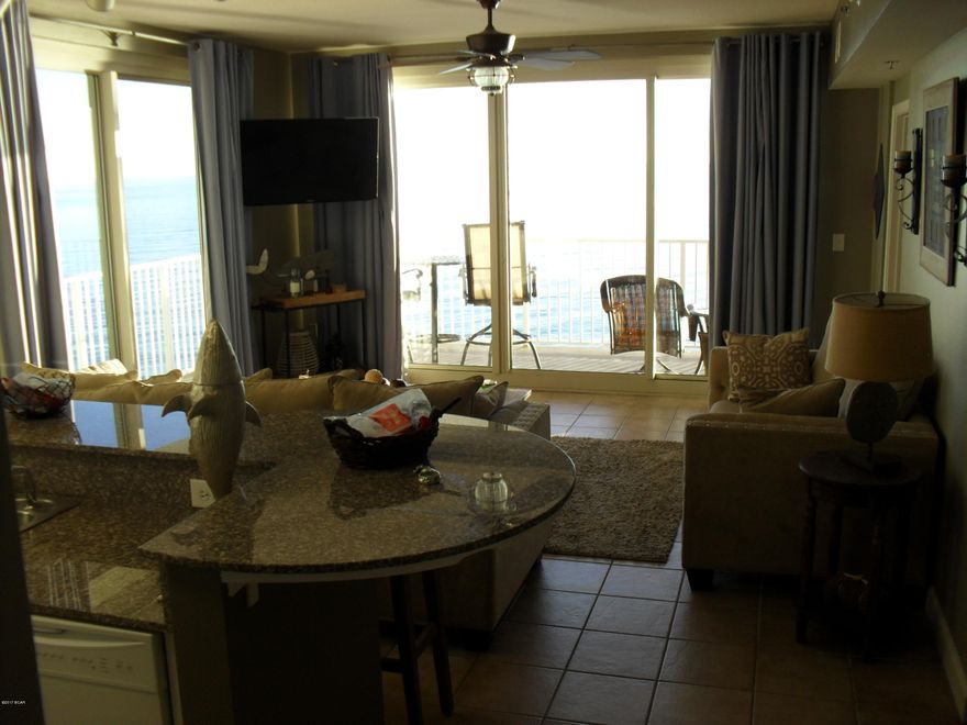 RARE opportunity to own a 2/2.5 bath beautifully decorated end unit with a corner wrap balcony!  Owners do not rent this unit.  As soon as you enter this Condo, you have a view of the Gulf of Mexico!  Condo is tiled throughout with the same beautiful neutral tile.  Kitchen has granite countertops, two separate closets/pantries for extra storage. A large master bedroom on the gulfside with sliding door to balcony, as well as a large picture window for gulf breezes, sounds and views.  Second bedroom features 2 Full size beds. Sellers added New Full size washer/dryer, new hot water heater, furniture, and paint in 2015/2016.  A third area is a Bunk room with a separate half bath.  Easily sleeps 8+ people.  Living room has two large sliding door/windows to access wrap balcony, and for fantastic views.  This unit also comes with an assigned parking space located directly by the door to condo units.  Never have to use an elevator!  Make your appointment to view today!