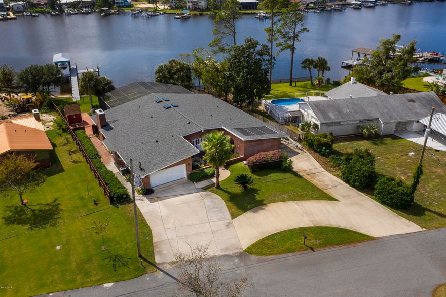 WATERFRONT HOME w/Gulf & Bay Access by Boat! 105 feet on the water located on private & quiet street tucked away just off of North Lagoon Drive - 1/2 acre lot. 10 minutes to the Gulf of Mexico by boat and 5 minutes to the beach by car!! Huge outdoor living space w/ Screened Lanai & Heated Pool. Covered Boat Dock w/10,000lb Lift, water & power - deep water channel in this location. This meticulously maintained home has panoramic views of the water!