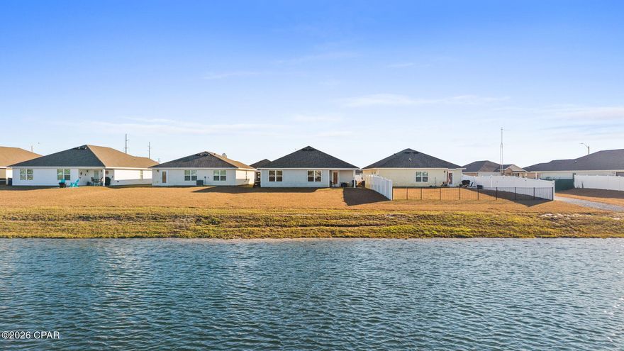 Built for comfort, designed for function, and positioned on the water—this well-kept home offers the kind of everyday living that just makes sense. Step inside to an open-concept layout that balances clean design with practical space, making it ideal for both daily routines and effortless entertaining. The kitchen serves as the heart of the home with white cabinetry, stainless steel appliances, generous counter space, and a large center island that opens directly into the dining and living areas. Neutral finishes, recessed lighting, durable luxury vinyl plank flooring, and upgraded ceiling fans throughout give the interior a modern, move-in-ready feel.

The living room is bright and inviting, anchored by peaceful backyard and water views that bring in natural light and create a relaxed atmosphere. The primary bedroom offers a comfortable retreat with room to unwind, while the additional bedrooms provide flexibility for guests, a home office, or hobbies. Smart-home features add an extra layer of convenience and security, including electronic Eufy door locks on all doors and exterior security cameras that will convey with the home.

Out back, a covered patio overlooks a tranquil pond, offering a private outdoor space perfect for grilling, relaxing, or enjoying quiet mornings with a view. The backyard is also equipped with a 50-amp receptacle and upgraded electrical panel, providing the option for a hot tub, RV, or additional outdoor power needs. An updated HVAC system with WiFi compatibility adds efficiency and modern control, making everyday living even more comfortable.

Located in a growing Panama City community with convenient access to Tyndall Air Force Base, shopping, schools, and major roadways, this home offers both location and livability. Whether you're looking for a primary residence or a smart long-term investment, 6481 Slabinski Lane delivers comfort, views, and value in one solid package.