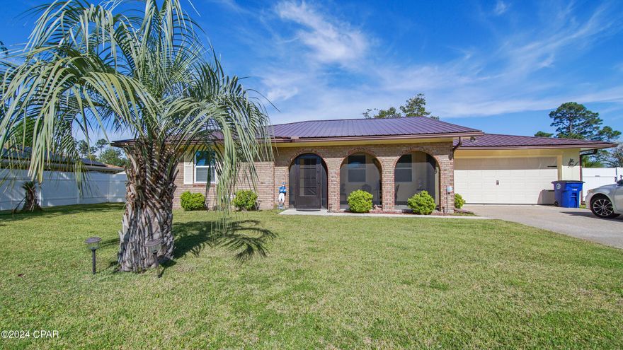 CURRENTLY UNDER CONTRACT . SELLER WILL CONSIDER BACKUP OFFERS. Immaculate 3 bedroom 2 bath home with tons of upgrades! The possibilities for this home are unlimited ! It features a huge screened in porch with fenced in yard and a yard building along with a spacious covered front porch! Home has a new metal roof and gutters and a new garage door! The functional kitchen has plenty of cabinet space and mircowave,, dishwasher and pantry. Gas water heater. There are 2 possible living spaces in this home with a dining area also. No carpet here! All flooring is porclein tile and is beautiful and low maintanence! Master bedroom features a walk in closet and a shower in the master bath with granite countertop. The other 2 bedrooms are spacious also with an additional 2nd bathroom. Home also has a sprinkler system that has been added! This home is so close  to the water too! Make an appt to see this one today!