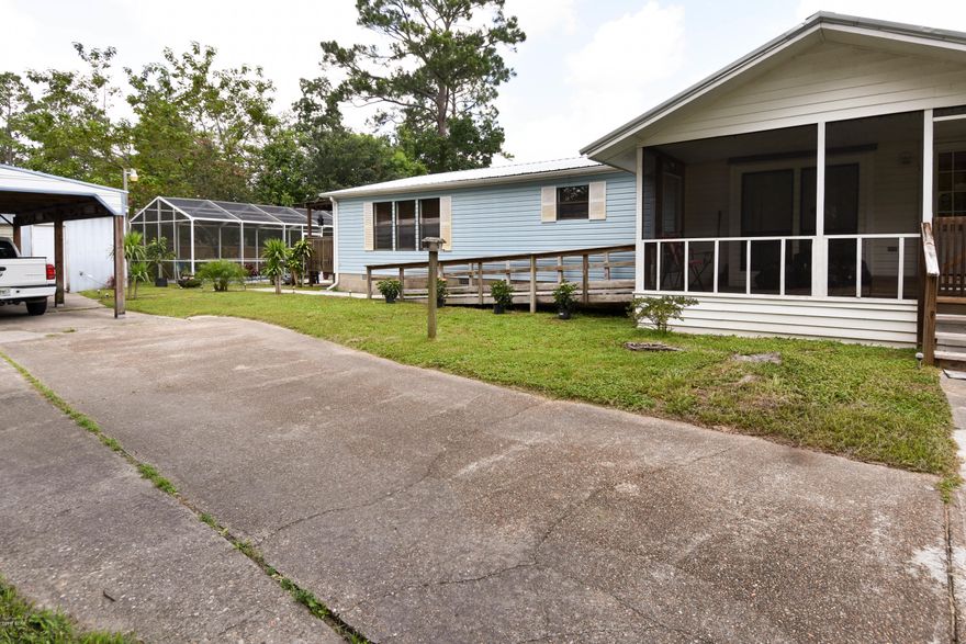 **The Seller is providing a 1 year home warranty!** This home is 1/4 mile from the swimming area and boat ramp on Deerpoint Lake. Spacious 3 bed, 2 bath, modular home on block foundation/anchored. There is a fence that surrounds the property with a solar powered, remote controlled gate at entrance to driveway. Screened in Pool and Patio with covered deck overlooking the pool. The property has city water and sewer, but a well exists also. New metal roof in 2013, the exterior is well lit, and has a security system. There is a separate 2 car garage plus large carport. Home is located in Flood Zone X and does not require Flood Insurance. Lender approval letter is required with all offers.  All information and measurements should be verifie This mobile home is on a permanent foundation.  The pool is also equipped with jets/spa; so enjoy relaxing in the pool after work.