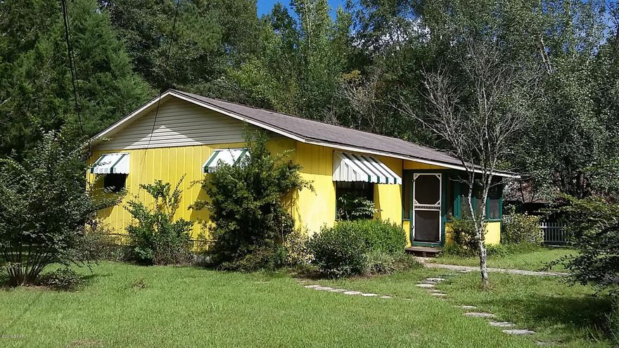 REDUCED! Great home on pretty lot in Vernon City Limits. Open floor plan in this 1 bedroom, 1 bath spacious home with double-pane windows and central heat/air. Tile in the foyer, kitchen, hallway and large bathroom. Plenty of wood cabinets and counter tops in the large kitchen with eat-at bar. Laundry room has a double-sink and storage. Even offers a convenient computer nook. 1394 sq. feet under roof, with 1092 sq feet being centrally cooled & heated. Screened back porch to enjoy the beautiful back yard. Easy to maintain 1/3 acre has a grapevine & even the white picket fence along the newly repaved road. Just down the road from the football field. Great location is convenient to Chipley, Interstate 10 in Bonifay, plus Panama City Beach. Very Motivated Sellers - bring all offers!