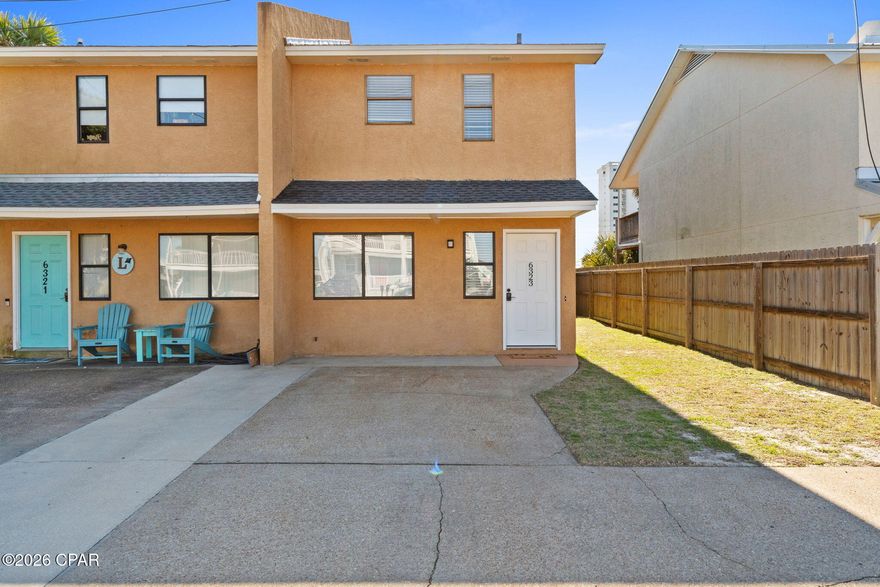 Welcome to 6323 Beach Drive in Panama City Beach Florida. This adorable 2-bedroom, 2-bath townhome is just blocks from three public beach access points and the emerald-green waters of the Gulf! From the moment you arrive, you'll love all the benefits this home provides --private parking, a low-maintenance fenced yard, and no HOA. 
The first floor includes 2 bedrooms and 2 full bathrooms, convenient laundry closet, and abundant storage space. Step out the back door to an ideal spot for entertaining and enjoying the beautiful weather and ocean breeze. There's also an outdoor storage closet for all your beach gear and other outdoor essentials. The second floor boasts an open concept kitchen that flows into a spacious dining and living room with ample natural light. An expansive covered deck awaits just past the back door, offering a front-row seat to breathtaking sunset views. Being sold fully furnished and rental-ready, this home is truly turnkey -- ready to move in, rent out, or enjoy as your private beach escape. This property affords incredible income potential as well as a relaxing personal getaway. Located on Thomas Drive, this peaceful area is known for its convenient sidewalks, family-friendly atmosphere, and proximity to the best of Panama City Beach -- including St. Andrews State Park, Pier Park, marinas, local restaurants, golf courses, and shopping. Don't miss your chance to own a piece of paradise. Whether you're searching for a primary residence, second home, or investment property, this townhome checks every box.