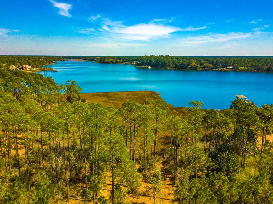 Serenity awaits on the beautiful residential lot in the popular gated Laird Bayou subdivision. This waterfront lot has direct access to the Gulf of Mexico, deep sea fishing, Shell Island and the world's most beautiful beached. Amenities of the neighborhood include pool, pool house with parking, bathrooms and lockers, community boat ramp and dock, gated community RV and boat storage. The owner has already thoughtfully cleared the lot so it is easy to access, walk and view the panoramic waterfront views.