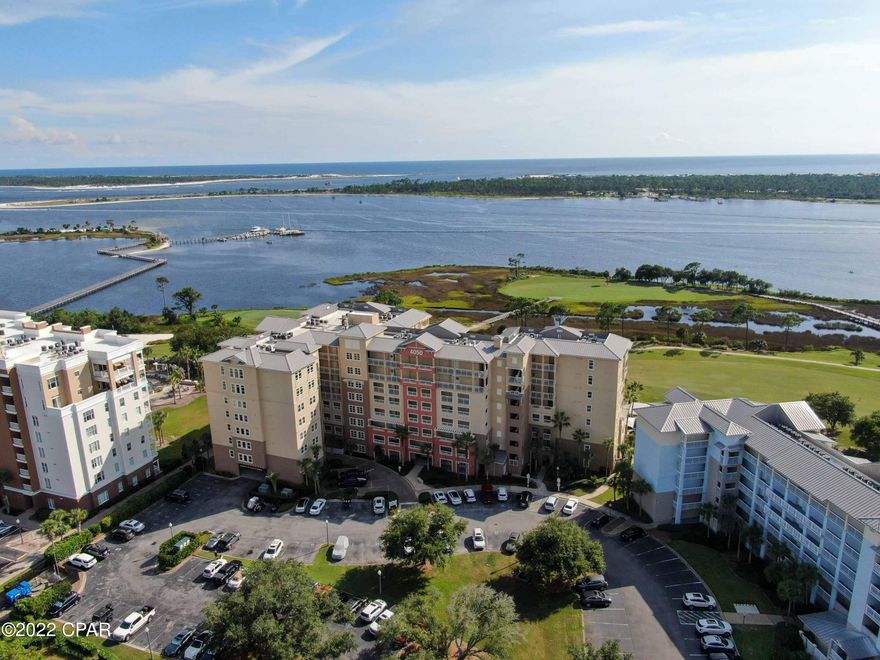 Welcome to one of the most Prestigious Condos in the Florida Panhandle! Step inside this Luxury Condo and be WOWED! Your 3 bedroom, 3 bath plus office condo overlooks Hole #5, The Prettiest Hole at Bay Point Golf Course and the beautiful Grand Lagoon! Your Waterfront Condo offers elegance throughout - beautiful tile floors, upgraded lighting features, a built in cocktail bar, granite countertops plus more. This unit has a separate Climate Control Storage Unit. Enjoy the large pool area which includes a hot tub, fire pit and grilling area. Wanna get in shape? The Fitness Center is top notch with all the machines and dumbbells that you will need! Entertain your guests with a friendly competition of ping pong or pool. The HOA has lots of fun throughout the year! WELCOME TO BAY POINT!