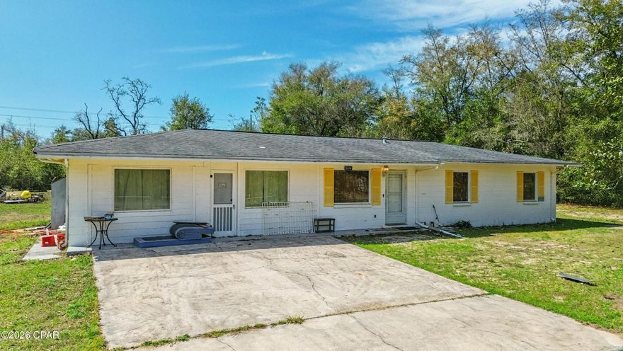 No HOA, 1 Acre of land, 4 bed 2.5 bath, block home!!! Discover the perfect blend of modern living and rural freedom in this well-maintained concrete block home, nestled on a peaceful, wooded one-acre lot in the heart of Bayou George. With no HOA restrictions, this property offers true independence, featuring a cleared area around the home ideal for parking boats or RVs, complemented by a back concrete patio and separate outbuildings for all your storage needs. The spacious 1,664+ square foot interior boasts an open-concept layout with four bedrooms, 2.5 bathrooms, and attractive hardwood-look tile flooring throughout. The chef-ready kitchen is equipped with a gas range, stainless steel appliances, and stylish barn doors, while a generous walk-in laundry room and gas tankless water heater add modern convenience. Key high-value extras include a private deep well with a Culligan water softener, a 250-gallon in-ground propane tank, and an active AC maintenance agreement with Peaden for added peace of mind. Located just a short drive from the boat ramps at Deer Point Lake and the amenities of Panama City via Highway 231, this move-in-ready gem is the ideal sanctuary for those seeking a wooded retreat with city accessibility. Schedule your showing today!