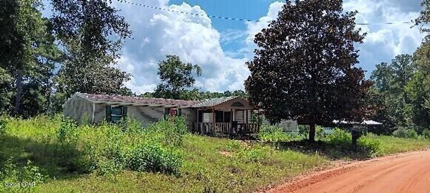 Spacious Acreage with Pond & Pole Barn

Discover the possibilities on this 1.54-acre property featuring a large pond, pole barn, and plenty of open space. The land is partially fenced and includes an older dock by the pond, offering both character and potential for restoration or customization.

A 2001 mobile home (4 bedrooms, 2 baths, over 2,000 sq. ft.) is located on the property. The home has experienced fire damage and is not currently in livable condition, but utilities are in place, making this an excellent opportunity for a new build, replacement home, or renovation project.

With a spacious pole barn for storage or workshop needs, water features, and a private country setting, this property is ideal for someone looking to create their dream homestead, hobby farm, or rural retreat.

Bring your vision and see what this property can become!

Less than 45 minutes to the World's Most Beautiful Beaches, less than 15 minutes to Interstate 10 this beautiful, peaceful lot is country living with the convience of nearby town life.