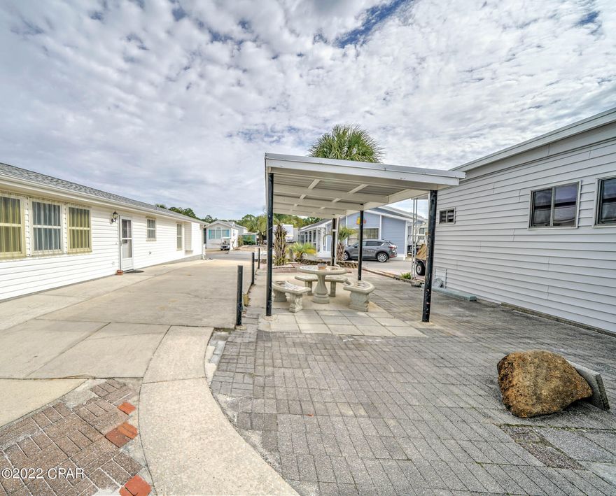 Check out this beautiful lot in popular Venture Out. This lot is in the perfect location within the resort. It's super close to the front and you get extra parking in the back. You will love the large awning and patio area.   This lot also has a good size storage shed with room for washer/dryer.  Build your dream home or bring your RV! This one won't last long as lots are highly sought-after! Venture Out offers BOTH beach and bay access! The resort also has 2 pools, tennis, golf, shuffleboard, playground, basketball, fishing pier, boat dock with slips & boat ramp. Venture Out is a golf cart community that has exploded in popularity within the last few years. A gated community that's great for full time residency or just to vacation. 24-hour security & friendly atmosphere. It's all here!