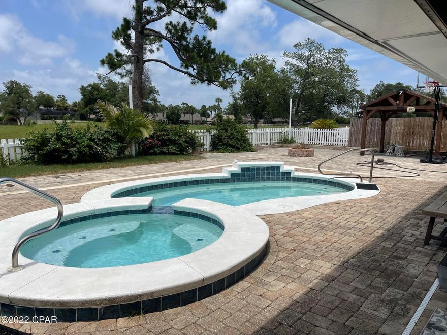 Beautiful home located in Bay Point! Updated kitchen features granite counter tops, stainless steel appliances, and kitchen island with electrical outlets. Open concept floor plan with dining area that flows nicely into the living room, which features a stone gas fireplace with remote control starter. French doors lead out to the heated pool and spa, and paver patio with 2 large pergolas. Master suite was completely updated in 2017 with new flooring throughout and a master bathroom with marble counter tops, double vanity, and tiled shower with rain shower head. Another set of French doors leads from the master to the outside living area, equipped with television hookups. Garage has tons of storage, built-in cabinets with granite countertops.  Located just minutes away from the beach, Bay Point is a gated community, with full-time security and golf cart-friendly neighborhood with a marina.