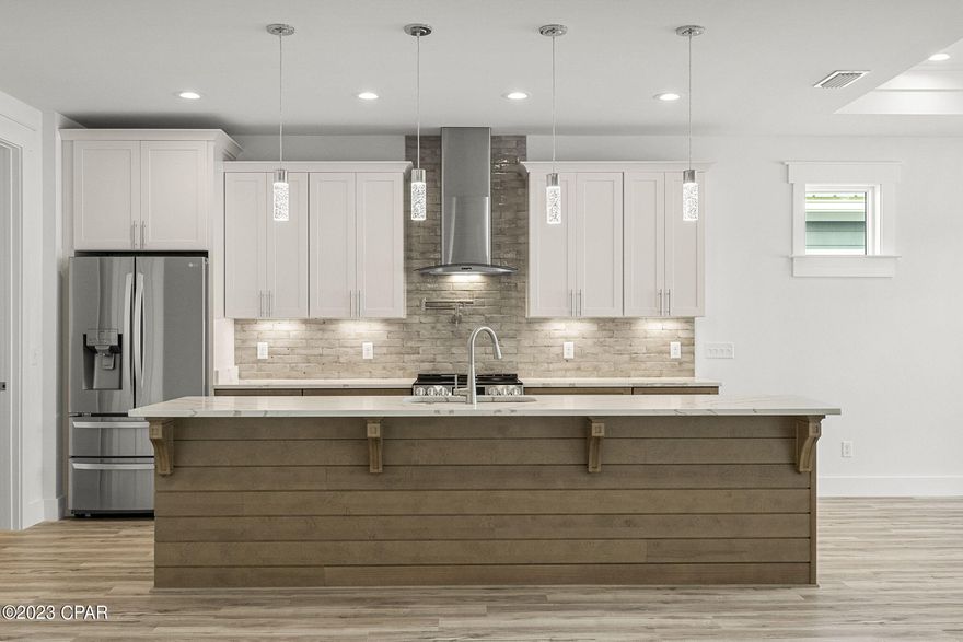 CURRENTLY UNDER CONTRACT, SELLER WILL CONSIDER BACKUP OFFERS. Brand-new home nestled in the tranquility of West End Panama City Beach. Enjoy the peaceful ambiance of one of the area's quietest streets while relishing in the convenience of being mere minutes from the Publix shopping center and the vibrant dining and shopping scene of 30A. This impeccable 3-bedroom, 2.5-bathroom residence showcases modern amenities designed for comfort and efficiency. 

Inside, the spacious interior features lofty 9-foot ceilings, complemented by elegant 8-foot doors. The kitchen is equipped with sleek quartz countertops, top of the line stainless steel appliances, and a pot filler offering a modern and durable cooking environment, while recessed lighting fixtures contribute to a contemporary ambiance. Tray ceilings in the master, living, and dining areas enhance the sense of space and style. The master bathroom is equipped with a double vanity boasting quartz tops, a tiled shower with a glass door, a separate water closet for privacy, and a walk-in closet for convenience.

With a durable metal roof and an energy-efficient natural gas tankless water heater, this home offers both durability and cost-saving benefits. Safety and peace of mind are paramount, as all windows, doors, and even the garage door are impact-rated, eliminating the need for hurricane shutters while capitalizing on insurance savings.

This property is an excellent choice for short-term rentals, making it an ideal investment opportunity. Situated on a serene street in the highly sought-after West End, you're just a short stroll away from beach access and a convenient boat ramp at Lake Powell. Don't miss your chance to experience the best of beachside living in this newly constructed gem!

Other features include: full gutters, 6' vinyl privacy fence, full landscaping w/irrigation, outdoor shower, tongue & groove porch ceilings, 8 foot sliding glass door, soft close cabinets, vented exhaust hood, drawer microwave.