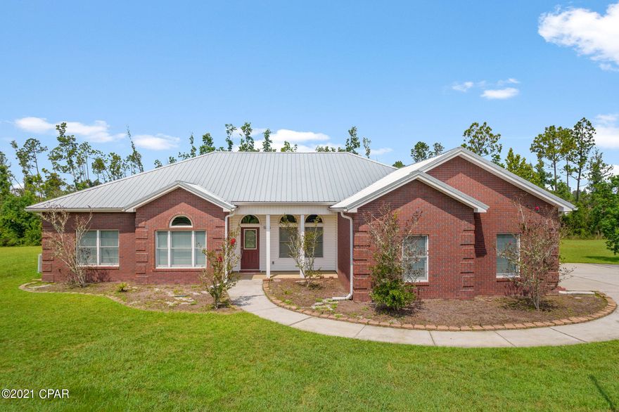 CURRENTLY UNDER CONTRACT, SELLER ACCEPTING BACKUP OFFERS Almost three acres, all-brick home, three bedrooms plus an office AND an in-ground pool  - this home is ready and waiting for you. Conveniently located close to shopping, parks, Tyndall Air Force base and fresh and salt water fun, you have room for family, pets, boats and gardens. As you enter the home, the spacious living room is ahead and the dining room with charming wood floors is to your right. The eat-in kitchen is open to the living room and features granite counters,  all appliances and a pantry. The master bedroom is large and has a door to the pool  and the master bath has double vanities, tub, separate shower and a walk-in closet. The additional two bedrooms are also nice-sized with a jack-and-jill bathroom between. In addition there is an office, a half bath and a laundry room. Outside,  the screened pool area has a covered patio with an attached hot tub and waterfall feature. There is also a pole barn with an enclosed workshop. In addition, there is a large three-car garage with a workbench and additional attic storage. It is hard to find three acres this close to town with a great house and a pool. Call your Realtor for your personal tour today