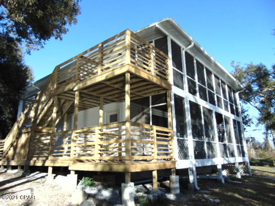 WATERFRONT!  Property sits on Newman Bayou that goes out to West Bay and the Gulf.  Boat landing/launch is just across the street from the property.

Country living with lots of shade trees, short drive to Lynn Haven and the beach.  Newly remodeled 3 bedroom 2 bath (2nd Floor) open floor plan with great view of the water.  Nice kitchen with granite counter tops, new stainless appliances LVP flooring throughout, large bathrooms, laundry closet for stackable W/D (W/D Hookups), large screened porch on waterfront, open patio for grilling.  Nicely landscaped!  Well & Septic Tank, All Electric and Gulf Coast Electric services this area.

Nice relaxing panoramic view of the water.

1 small pet under 20 lbs is negotiable!