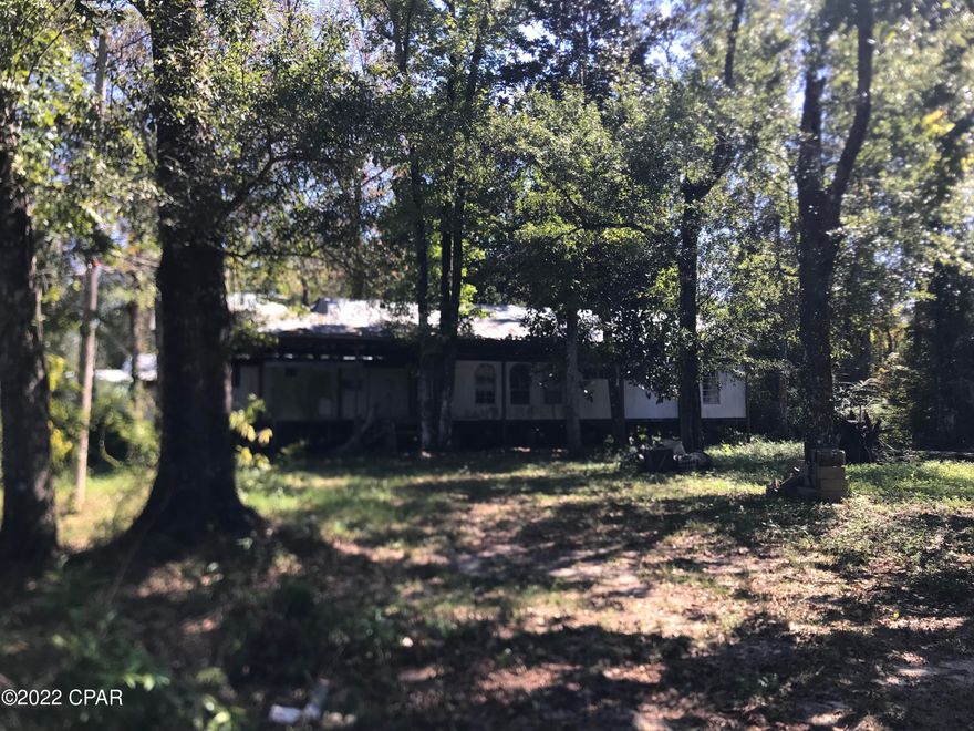 WALK TO THE WATER FROM YOUR PROPERTY. FISHERMAN'S PARADISE. 
Lot in Wewahitchka, Fl. with Pole Barn already in place for shade. Beautiful view of the Chipola River within walking distance.  Old mobile home sits underneath the Pole Barn structure.  Mobile home could possibly be rehabbed, moved out & another one put in its place or build your very own new dream home.
 Chipola River & Dead Lakes Recreational Area located very close.  
If you love fishing, this area is home to one of the richest eco-systems in Florida.  Bass anglers come to this area to catch the ''Big Boys.''  
Drive by today & see for yourself why nature lovers, sports fishermen & photographers flock to this area.