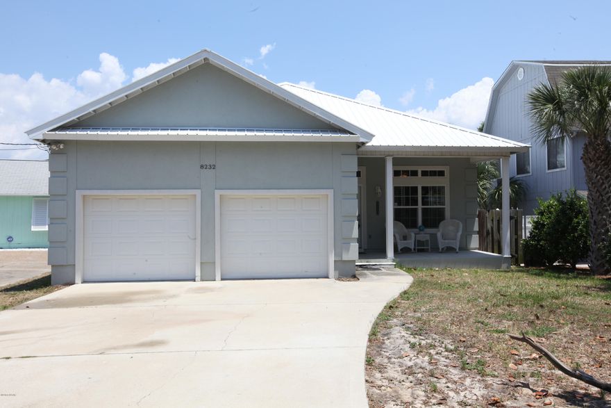 This is a waterfront home located on Grand lagoon with 3 bedrooms, 2 baths and a 2-car garage.  The interior features a remote controlled fireplace in the living room, a large kitchen with breakfast bar, built-in shelving, and tile throughout.  The master suite features hardwood floors in the bedroom and a Jacuzzi tub & separate shower in the master bath.  Exterior features include a covered porch, boat slip, covered boat lift and dock! It is a must see!