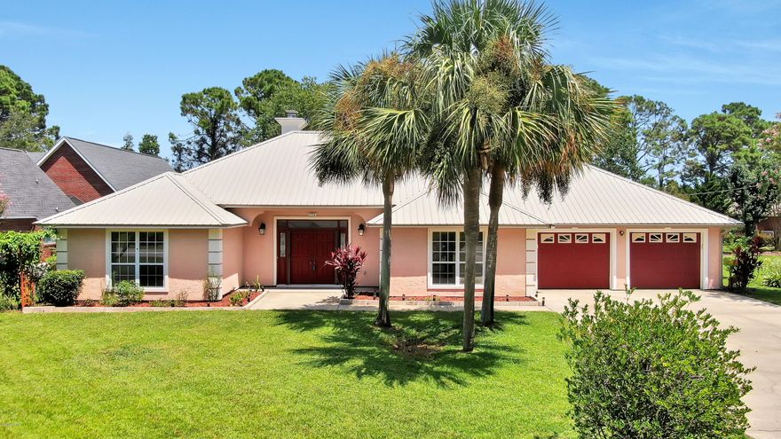 Wow! This golf course home has features anyone would want! Metal roof, media room, whole house sound system, 2 AC units, 2 water heaters and almost a ½ acre lot just for starters! This home has a split floor plan, beautiful finishes, upgraded features, and gives you lots of space to enjoy. Most rooms offer dimmable lighting and separate sound controls.  The living room boasts high ceilings, crown molding, recessed lighting, a fireplace, and French doors to the back patio. The master suite has its own AC and water heater and the en suite has a double vanity, relaxing whirlpool tub, separate shower and walk in closet. The 3 guest rooms are good sized and one has even been set up as a media room for the perfect movie night! The guest bath has a double vanity and separate water closet, making it easy to share space on those busy mornings. Enjoy holiday dinners in the formal dining room or have breakfast in front of the bay window in the eat-in kitchen.  The chef will enjoy lots of countertop space for cooking, stainless appliances, tile backsplash, abundant cabinets, and a pantry.  2 full size garage spaces are great, but don't overlook the bonus room in the garage! It is heated/cooled, offers cabinet space and is soundproof, once a music studio, it could now be a great office space for the teleworker.  Mature trees give the oversized backyard privacy. Watch the kids or pets play, plant a garden, or relax on great patio area. The pergola and outdoor speakers will make a perfect setting for any gathering. Steel studs on the exterior walls, well water irrigation, underground utilities, a large driveway, and No HOA fees are more bonuses for a buyer! The location is not only on the Holiday Golf Course, but it's also near recreation paths that connect to Gayles Trails, is minutes to Pier Park and only 1 mile to our beautiful white beaches. Seller is offering a one-year home warranty, transferrable termite bond and hurricane window panels for buyers' peace of mind.  All measurements approximate, buyer to verify if important.