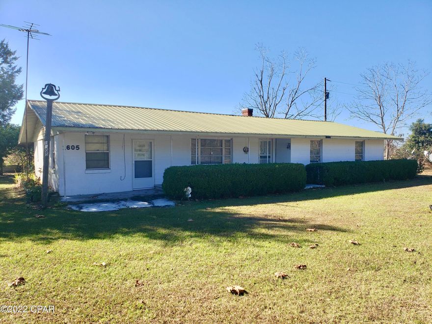 Quiet country living with acreage but easy access to I-10! This country home comes with approximately 28 acres. The property is located less than five minutes from the interstate, making it perfect for city commuters who want a little peace and quiet at the end of the day. The three bedroom, two bath home is surrounded by fruit trees and an abundance of garden spaces. The kitchen has a traditional farmhouse hearth and there is a separate dining area. A bonus room with separate entry is located just off of the large living area. The bonus room would make a great master suite (it has its own bathroom) away from the other three bedrooms and bath on the opposite side of the house. There is also a separate laundry area/mudroom and covered carport. This house is the epitome of "good bones" and a little TLC will bring your farmhouse dreams to life in the perfect location! Only minutes to beautiful Lake Seminole and the Apalachicola River. Easy 40-minute drive to Tallahassee.