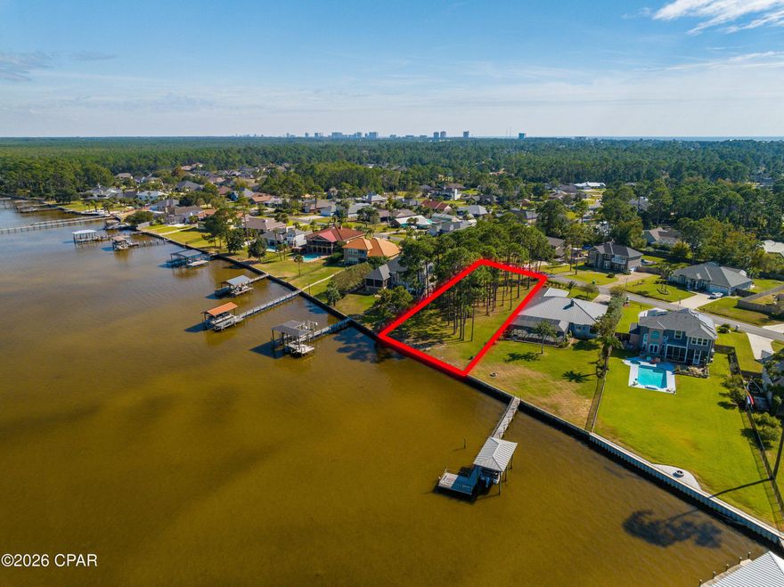 TRANQUIL BAYFRONT OPPORTUNITY | 101.1' OF WEST BAY FRONTAGE WITH GULF ACCESS

Discover a rare opportunity to create your legacy home at 306 Moonlight Bay Drive, a serene bayfront homesite nestled along the peaceful shores of West Bay in Panama City Beach, Florida.

This exceptional parcel offers 101.1 feet of bay frontage and is protected by a fortified seawall already in place, providing long-term shoreline stability while preserving the natural beauty of the property. The surrounding slow-moving saltwater marsh creates a calming, nature-rich setting—one of the Emerald Coast's most beautiful and quietly treasured environments.

Located within a designated West Bay sector plan, the area's natural resources are intentionally preserved and protected, enhancing both lifestyle and long-term value. From your future dock, enjoy a scenic 25-minute boat ride to the turquoise waters of the Gulf of Mexico, offering the rare advantage of both sheltered bay boating and easy Gulf access.

Despite its peaceful setting, the property is conveniently located near the best of Panama City Beach living, including shopping, dining, golf, and world-renowned white-sand beaches. This unique balance of privacy, accessibility, and natural beauty makes the property ideal for a custom waterfront estate or tranquil coastal retreat.

Opportunities like this—bayfront, buildable, and protected—are increasingly rare along West Bay. 306 Moonlight Bay Drive offers the chance to secure a truly special waterfront setting and build something lasting in one of Northwest Florida's most serene bayfront communities.