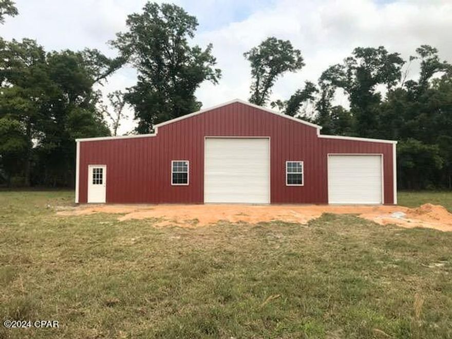 If you are looking for seclusion and a pretty mix of 20 acres of improved pasture plus almost 17 acres of native live oak hardwoods, you have found it! It has a very well-built barn/shop that was just built in 2022 which includes a fully insulated area with a minisplit for heat and cooling. The barn has an expansive shop area with large rollup doors, perfect for equipment storage.  The barn/shop has concrete floors throughout. Beautiful location for a new home. The location is perfect for commuting to Marianna, (voted as one of the top ten best small towns in Fl) a mere 10-minute drive.  Dothan, AL is about a 30-minute drive. The beaches are just about an hour south of this location, an easy drive for a day's outing!
There is a 30- and 50-amp electric service for an RV. This property is fully fenced for livestock. A new, excellent-quality water well was installed in 2022.
Grow just about any produce in your fully fenced garden area. Make an appointment today, as these types of properties are hard to find and don't last long! Deed restricted to 1800 sq ft H/C site-built homes. Now offering owner financing!