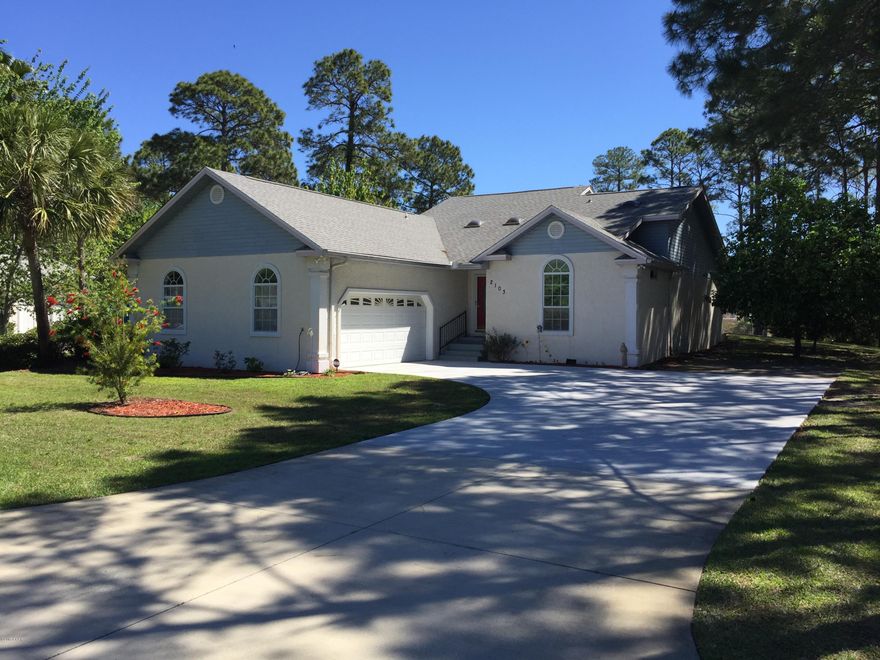 Wow! Welcoming home with lots of nice features. This is a large 2 bedroom, 2 bath on a .34 acre lot. Den/Office could be a 3rd bedroom. Kitchen has Lots of counter top space plus 42'' cabinets with pull out shelves and lazy susan. Separate pantry, cabinets and sink in the laundry room. The master bedroom has a walk-in closet and trey ceiling. Large master bathroom with double vanity and separate tub/shower. The irrigation system is on its own well. Mature grapefruit and tangerine trees. Enjoy the screened/glass sunroom day or night.  There are even 4 skylights and a big garage. You will not find more bang for the buck on the beach.