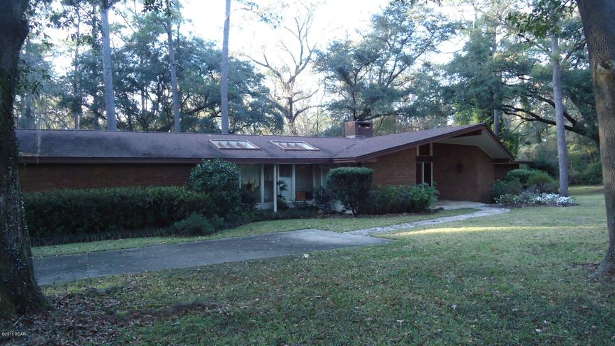 THIS HOME SITS ON OVER FOUR BEAUTIFUL ACRES. HOME IS LARGE AND SPACIOUS WITH ALMOST 4000 SQ FEET HEATED AND COOLED.HOME IS OF CONTEMPORY STYLE AND UNIQUE.LIVING ROOM HAS LARGE WOOD BURNING FIREPLACE. 4 BEDROOMS/3.5 BATHS ONE OF THE BEDROOMS WOULD MAJE NICE OFFICE. KITCHEN HAS AREA WITH A GREAT VEIW OF THE OUTDOORS. HALLWAY FEATURES STONE FLOORING. KITCHEN HAS A DOUBLE WALL OVEN  AND ISLAND JENN AIR COOKTOP.MAKE YOUR APPOINTMENT TODAY TO VEIW THIS LOVELY HOME.Large price reduction. Motivated seller.