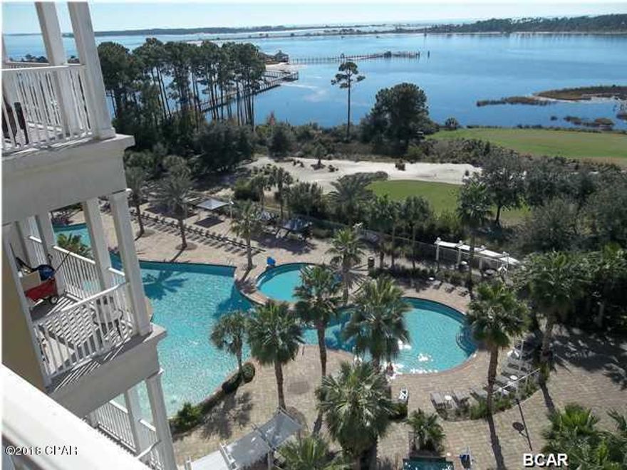 BAY - WATERFRONT CONDO! REFLECTIONS CONDOMINIUM located on Marriott Drive! Absolutely beautiful TOP FLOOR unit with waterfront views from the Living Room-Kitchen-Dining Area-Master Bedroom and from the Master En-Suite Bathroom!  This condo also has very high ceilings throughout because of being on the top floor views from front and back of this condo are beautiful...water, golf course, etc. Granite counters in the very open kitchen, Black appliances, all neutral tone floors and walls. Great room designed to enjoy the Bay Waterfront views. Master bathroom has Double Doors that lead you into the open bathroom floor plan with seamless glass shower doors, double vanity and granite counters. Second bedroom is located in the