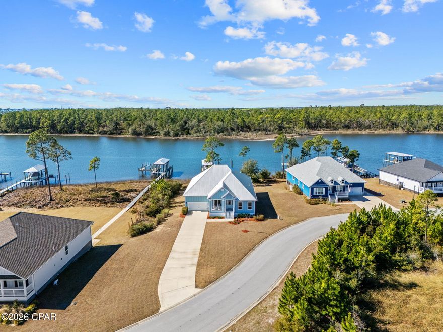 Waterfront Paradise with Boat House, Gulf Access, and Breathtaking Sunset Views Discover the ultimate waterfront lifestyle in this stunning 5 bedroom, 3-bathroom home featuring ~100 feet of prime waterfrontage and everything you need for seamless coastal living. With a 12,000 lb boat lift, a wet slip accommodating up to a 4 ft draft, and a 36 ft boat house. This property is perfect for boaters and water enthusiasts. The flow-through decking on the swim platform enhances durability and comfort, while the 50-amp service plug-in ensures your vessel is always ready for your next adventure. Step inside to an inviting open-concept floor plan designed for both relaxation and entertaining. The spacious living area is bathed in natural light, offering stunning water views from nearly every angle. The formal dining room is perfect for hosting special gatherings, while the flex space can serve as a home office, playroom, or additional lounge area. Outside, the oversized driveway provides ample parking for family and guests Downstairs, you'll find an expansive entertaining space designed for making memories, complete with a firepit—the perfect spot to unwind and enjoy the breathtaking sunset views over the water. This exceptional waterfront home seamlessly blends comfort, functionality, and luxury. Whether you're an avid boater, a sunset lover, or someone seeking a peaceful retreat, this property offers it all. If important, buyer to verify all information and measurements.
