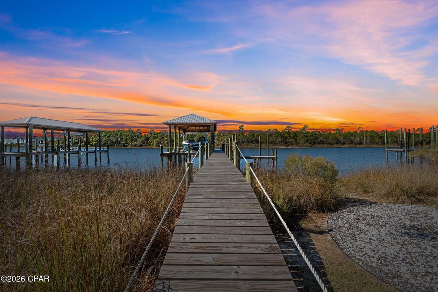 Waterfront Paradise with Boat House, Gulf Access, and Breathtaking Sunset Views Discover the ultimate waterfront lifestyle in this stunning 5 bedroom, 3-bathroom home featuring ~100 feet of prime waterfrontage and everything you need for seamless coastal living. With a 12,000 lb boat lift, a wet slip accommodating up to a 4 ft draft, and a 36 ft boat house. This property is perfect for boaters and water enthusiasts. The flow-through decking on the swim platform enhances durability and comfort, while the 50-amp service plug-in ensures your vessel is always ready for your next adventure. Step inside to an inviting open-concept floor plan designed for both relaxation and entertaining. The spacious living area is bathed in natural light, offering stunning water views from nearly every angle. The formal dining room is perfect for hosting special gatherings, while the flex space can serve as a home office, playroom, or additional lounge area. Outside, the oversized driveway provides ample parking for family and guests Downstairs, you'll find an expansive entertaining space designed for making memories, complete with a firepit—the perfect spot to unwind and enjoy the breathtaking sunset views over the water. This exceptional waterfront home seamlessly blends comfort, functionality, and luxury. Whether you're an avid boater, a sunset lover, or someone seeking a peaceful retreat, this property offers it all. If important, buyer to verify all information and measurements.