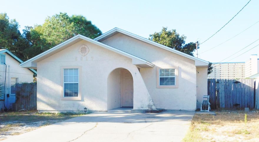 Cute, Cute, Cute! AND Location, Location, Location!  This 2 bedroom bungalow is JUST 2 blocks to Dolphin Street Boat Ramp on Grand Lagoon and across the street from The World's Most Beautiful Beaches and The Gulf Of Mexico!  And it's ''just the ticket'' for a perfect beach hideaway!  Good size great room / dining area with double doors that leads out to fenced back yard and covered patio. Master has walk in closet and also has double doors that lead to patio.  Second bedroom and full bath just off kitchen area which has all appliances and a pantry. AND it's clean as a whistle! Call today for more info!
