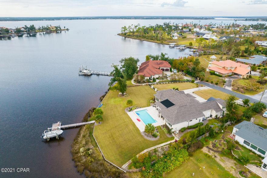 UNDER CONTRACT SELLER ACCEPTING BACKUPS.This magnificent estate is 222 ft of waterfront with gulf access and endless sunsets ! J. Michael Hunnicutt custom designed this pristine house. There are 10 and 12 ft ceilings throughout, 4 bedrooms and 4.5 baths plus a study/game room. The guest suite over the 3 car garage has a full bath and could be used as a 5th bedroom. This stunning home includes a whole house generator, central vacuum, tile floors, solar panels to heat the saltwater gunite pool, custom designer window treatments, coffered ceilings,Sub-Zero fridge, wine cooler, ice maker, Remi Halo purifier, multiple AC units, tankless H2o, gas fireplace, outdoor BBQ, No HOA! A dock, boat lift and seawall finish off this amazing oasis. See video tour!