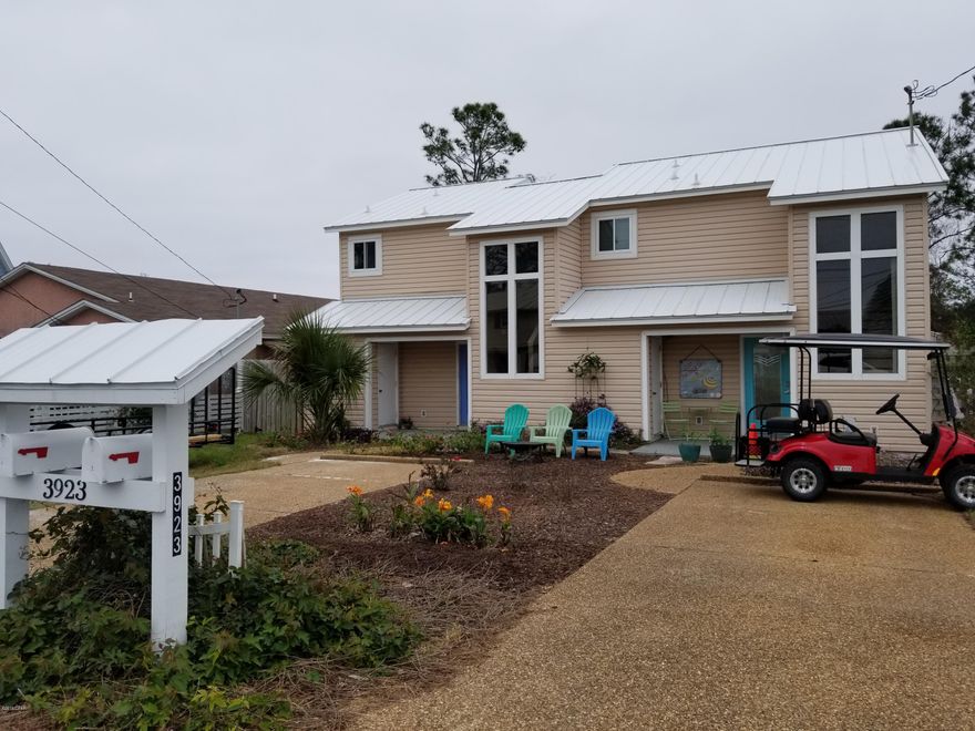 This beach house is like having two homes in one! One side is a 2 bedroom, 1.5 baths, the other side is a 1 bedroom, 1.5 baths and a short walk to the beach. Or it is a short walk to see Grand Lagoon and near the boat launch. It has a metal roof, vinyl siding, new windows, new paint, along with other updates. It has 2 driveways and 2 back covered decks. There are 2 storage sheds in the back yard. Both kitchens have lots of counter space and breakfast bars for family and friends. It is near St. Andrews State Park, Schooners, various restaurants and shops. For any family or investor, this should be considered. A family could live in both, live in one and use the other for guests, or rent one or both! It is move-in ready.