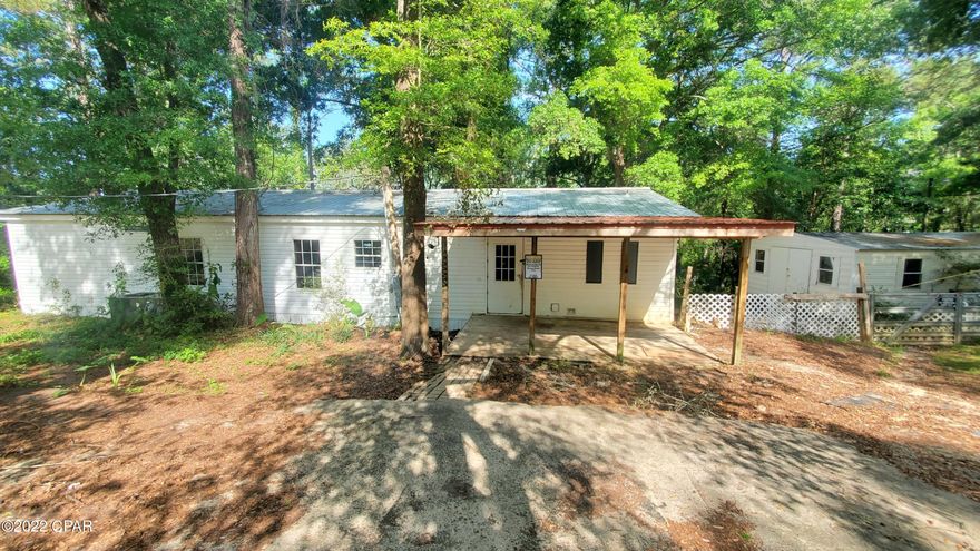 Under Contract, Taking Back up offers. New to the Market! On Lake Joiner! This spacious 3/2 features an open floor plan and has a huge deck overlooking the water. At .69 of an acre and plenty of trees, it feels very peaceful and private. Just minutes to Lynn Haven or Panama City Beach. Would make a great primary home, rental property, or getaway home. Split floorplan with a huge master suite and walk-in closet.  Septic tank, well , and metal roof are only a few years old. Dock and walkway from the home to the water needs some repairs. 20x24 Storage building. This home could use some cosmetic updates and repairs but could probably be lived in as you did the work. Priced to sell.