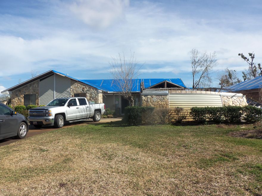 NEEDS WORK! ATTENTION CONTRACTORS/INVESTORS!

Storm Damaged home selling AS IS. Hurricane Michael dislodged front half of roof, and destroyed 2 car garage - mostly wind damage. Back half of house less damaged - rear (3 yr old) roof intact. Needs roof repair/decking and shingles/trim. Garage needs to be rebuilt. Interior needs some (not major) mold remediation and drywall repairs, new flooring, and paint, some fixtures and windows needing replacement, cosmetics, and could use updates. SELLING AS IS - SELLER NOT MAKING ANY REPAIRS. Seller has NEW house plans to either rebuild new same footprint  - or assist in determining needed repairs of remodel. No utilities on. Fireplace and yard well
